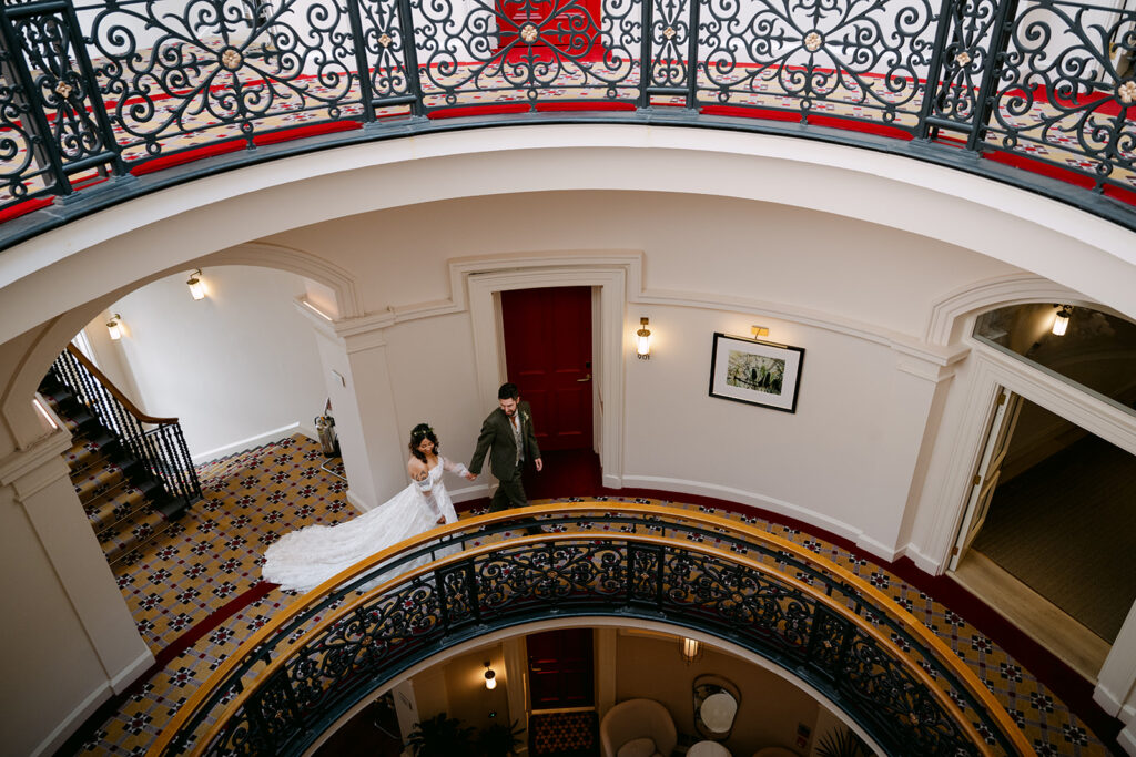 Interior balcony view of couple inside elegant building.