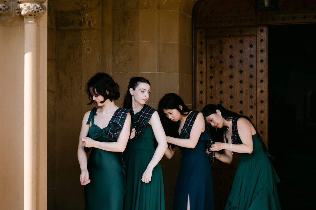 Bridesmaids standing together in matching dresses indoors.