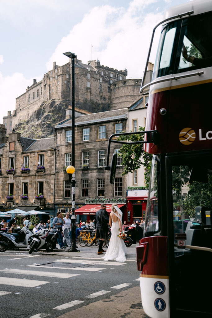 Edinburgh street scene with historic buildings and city life.