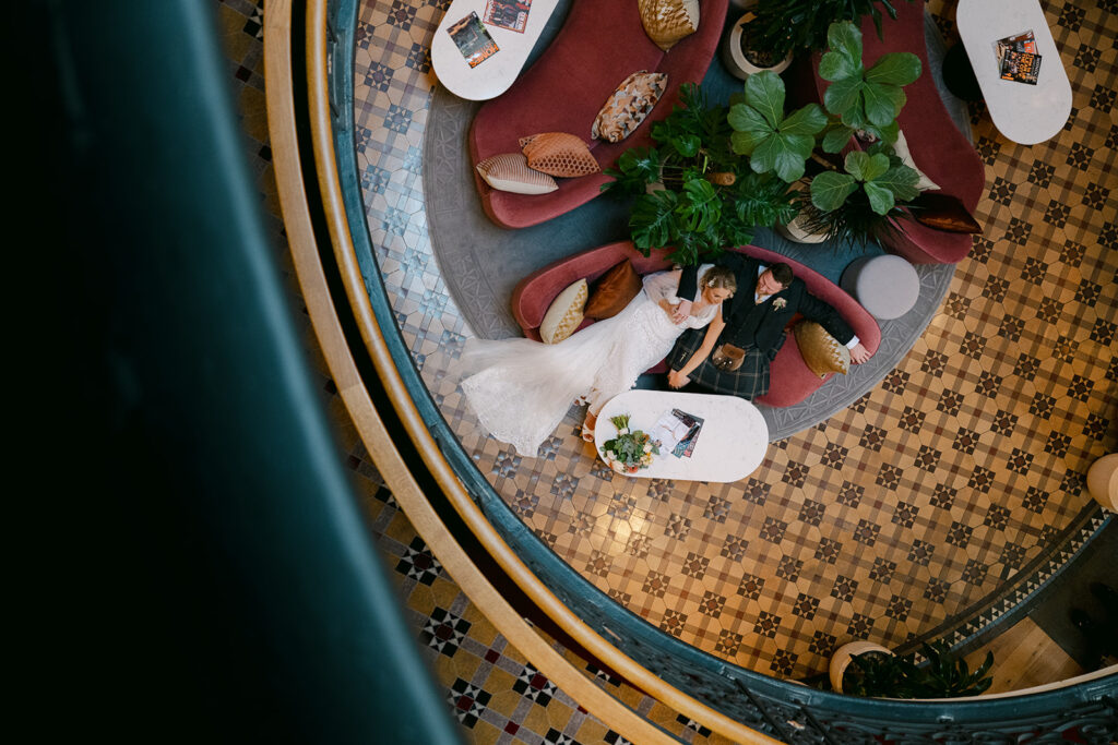 Overhead view of wedding dinner table with food and decor.