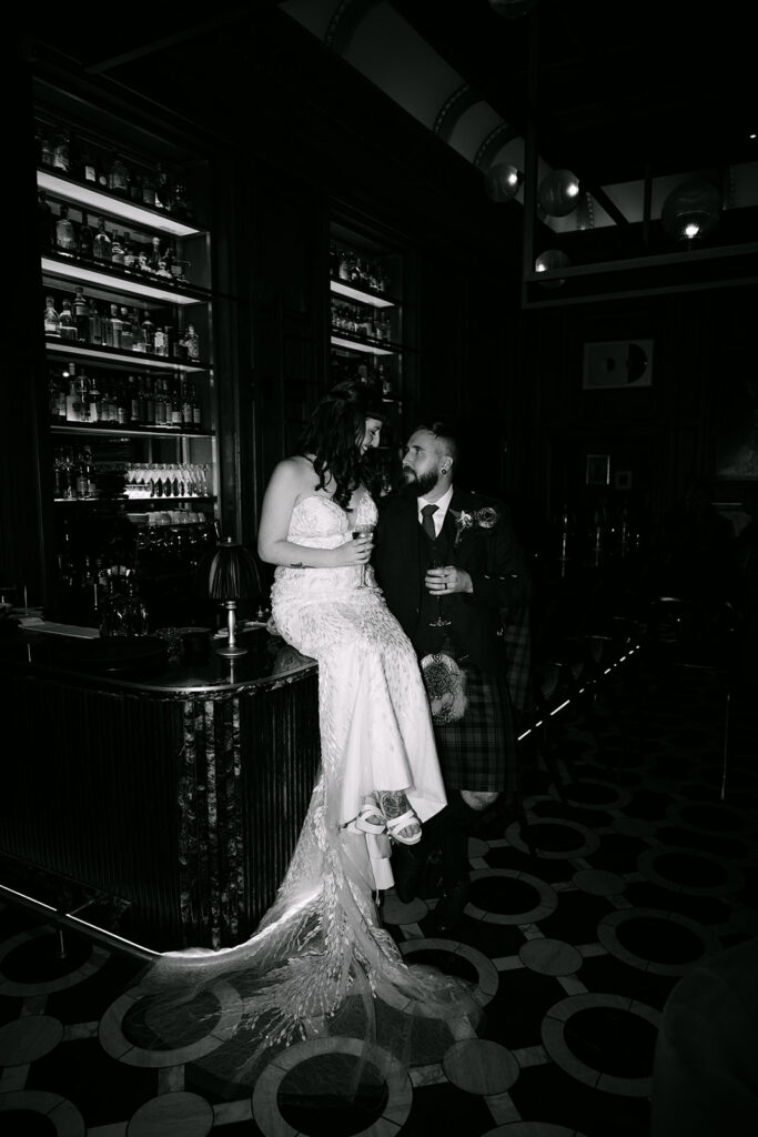 wedding couple in virgin hotels edinburgh sits in commons club bar