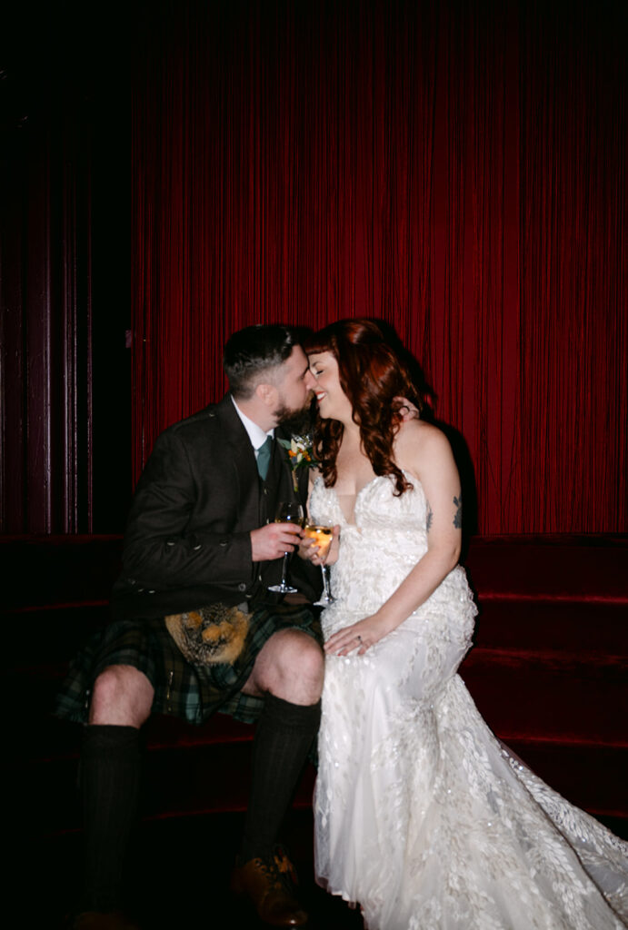 wedding couple in virgin hotels edinburgh kisses in Scarlett lounge