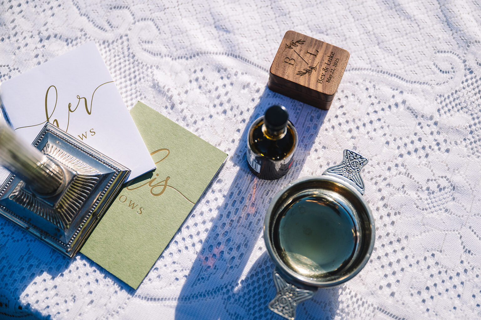Wedding details with invitation, ring box, and styling accessories.