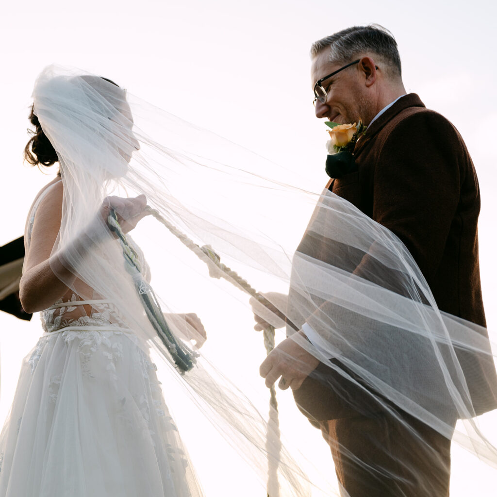 wedding couple holding a knot for their ceremony