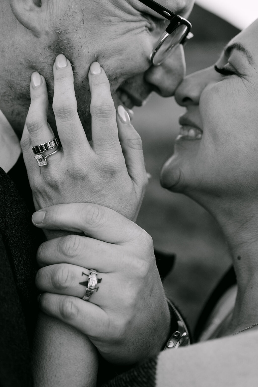 close up of rings on bride and grooms hands