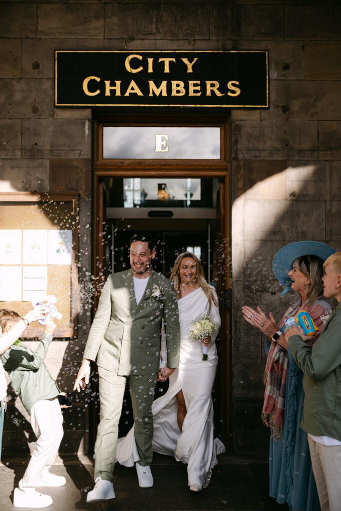 couple exits edinburgh city chambers through bubbles