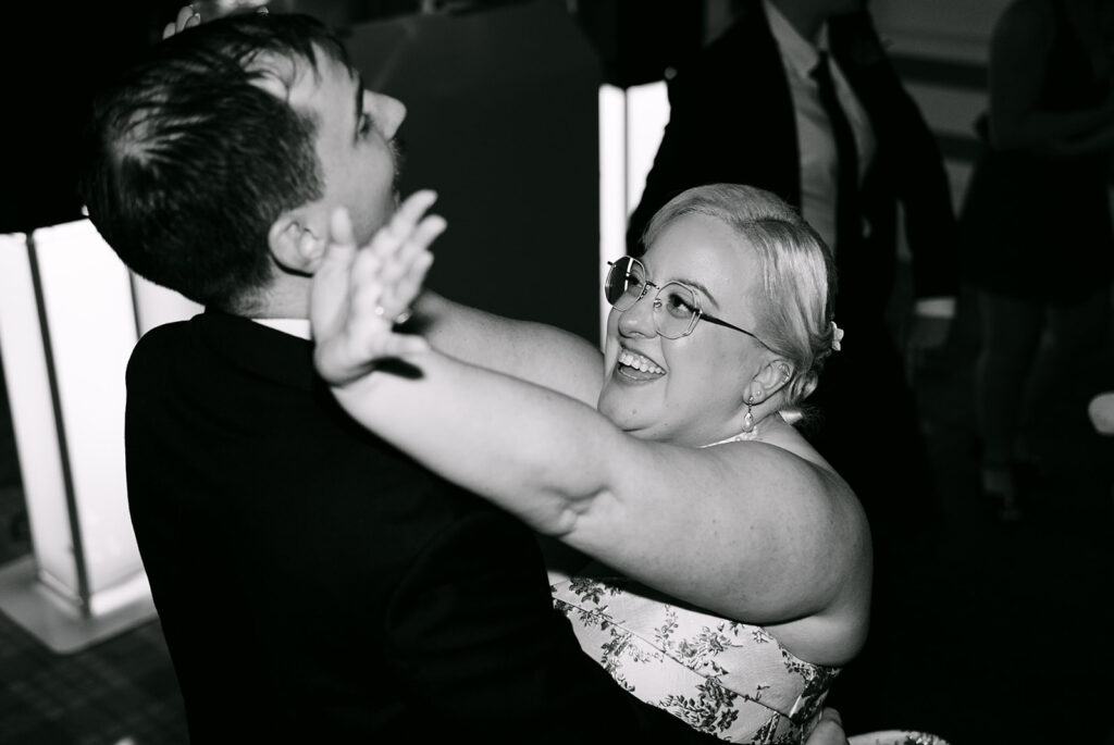 bride dances with groom and smiles