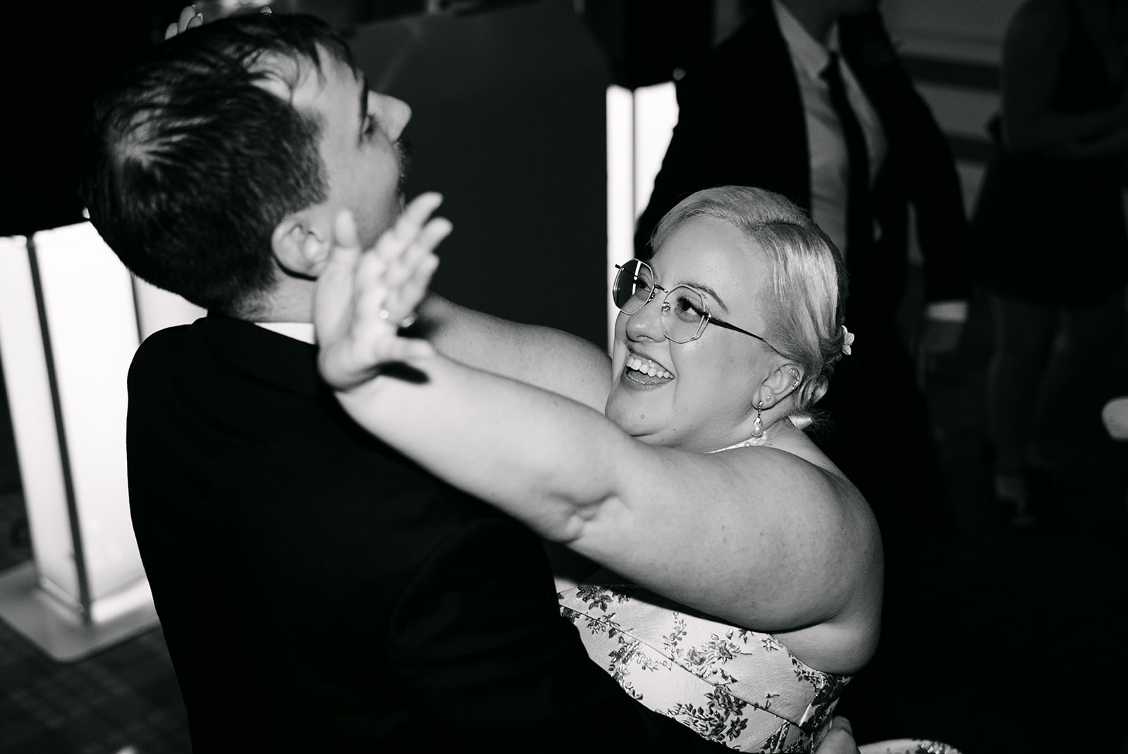 bride dances with groom and smiles