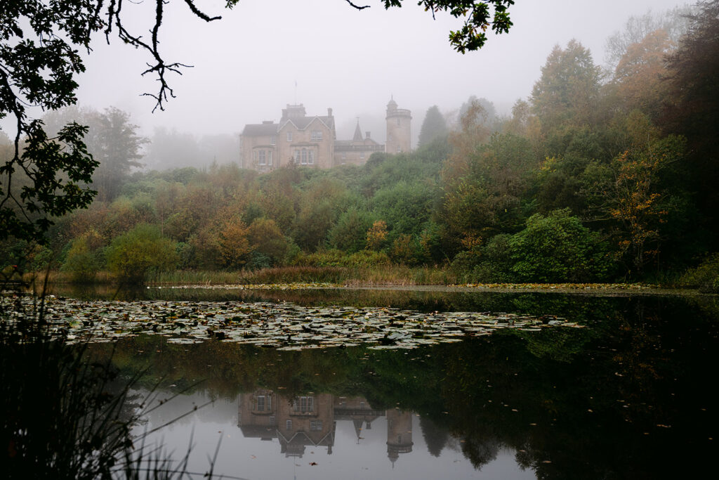 auchen castle sits above a misty loch