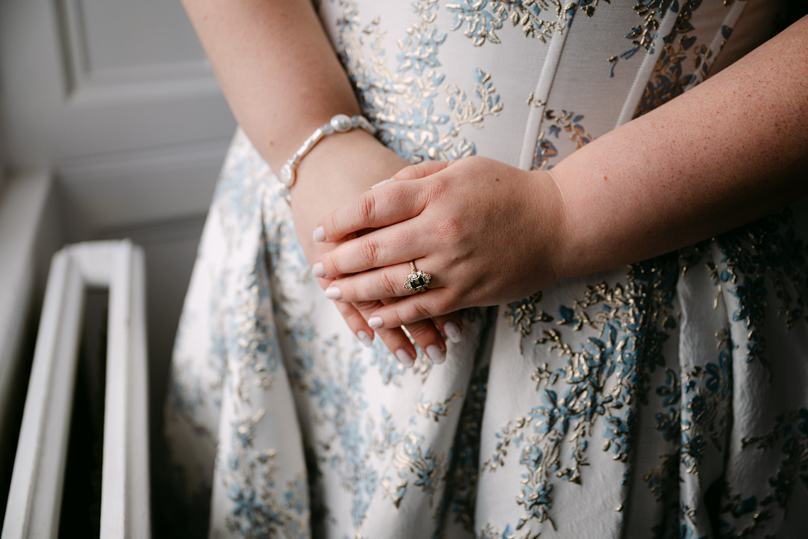 close up of rings on bride and grooms hands