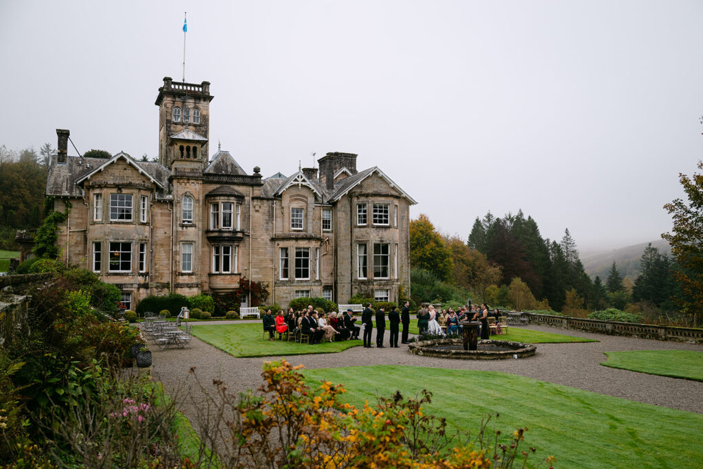 outdoor ceremony on the grounds of auchen castle scotland
