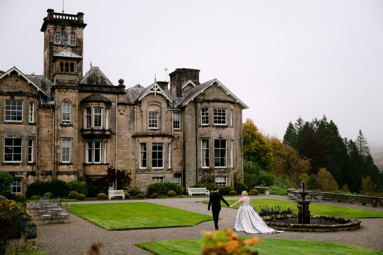 bride and groom take a walk on auchen castle grounds