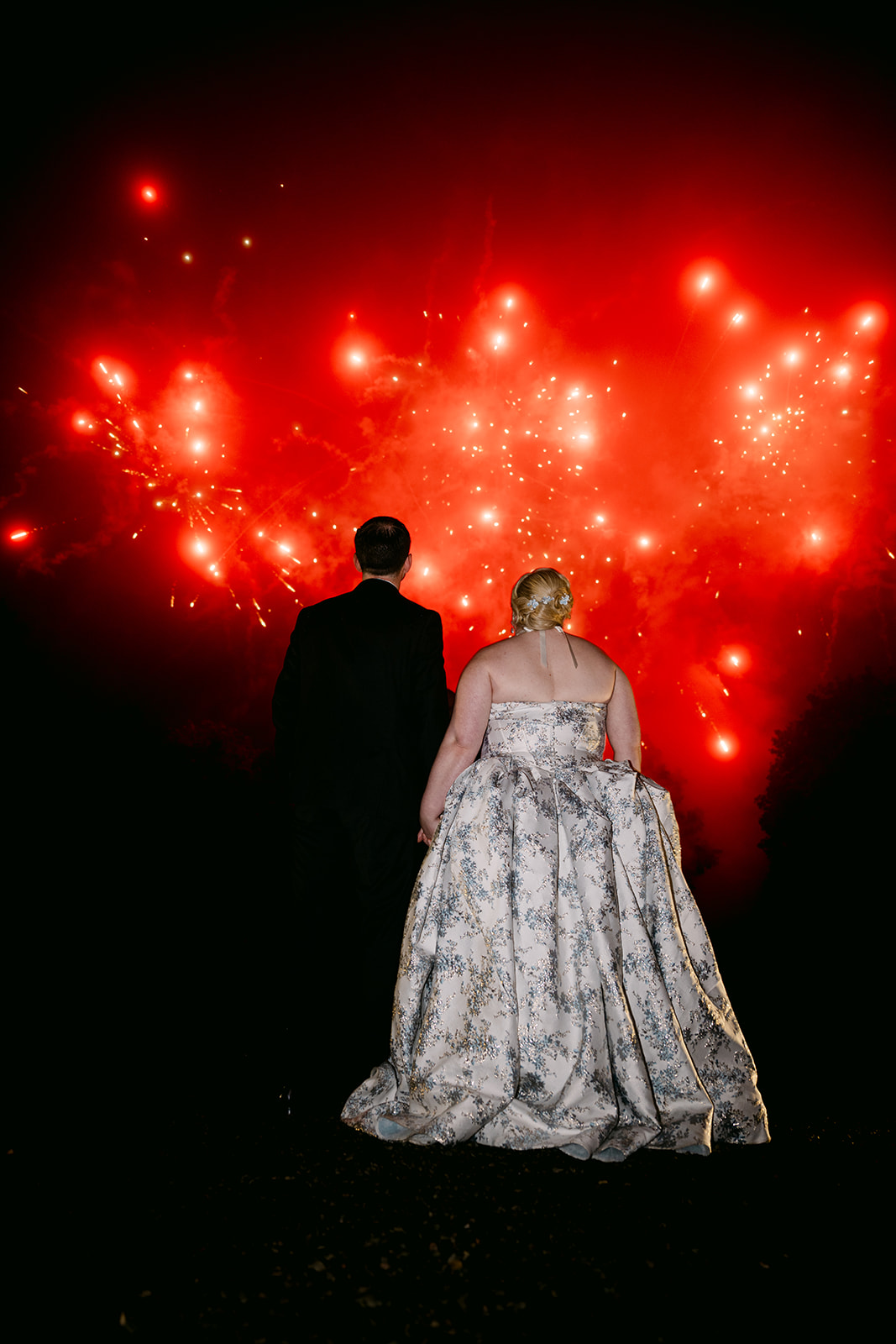 recently married couple watches fireworks at auchen castle wedding