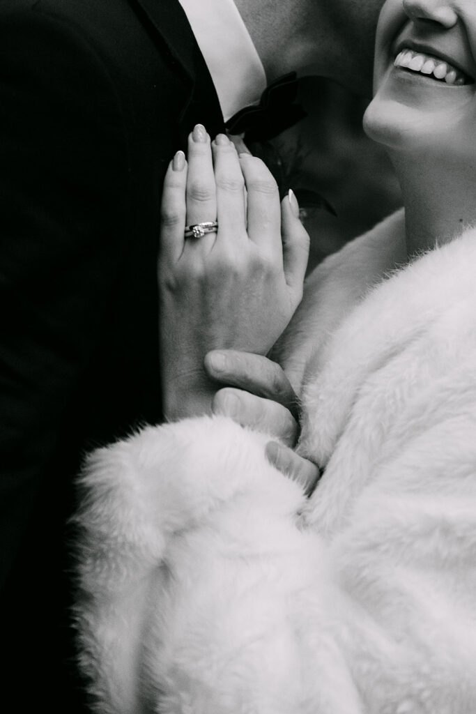 close up of rings on bride and grooms hands