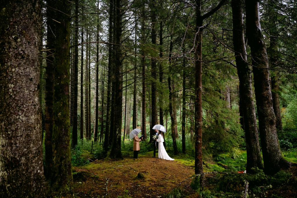 couple elopes in forest during on rainy day in glencoe