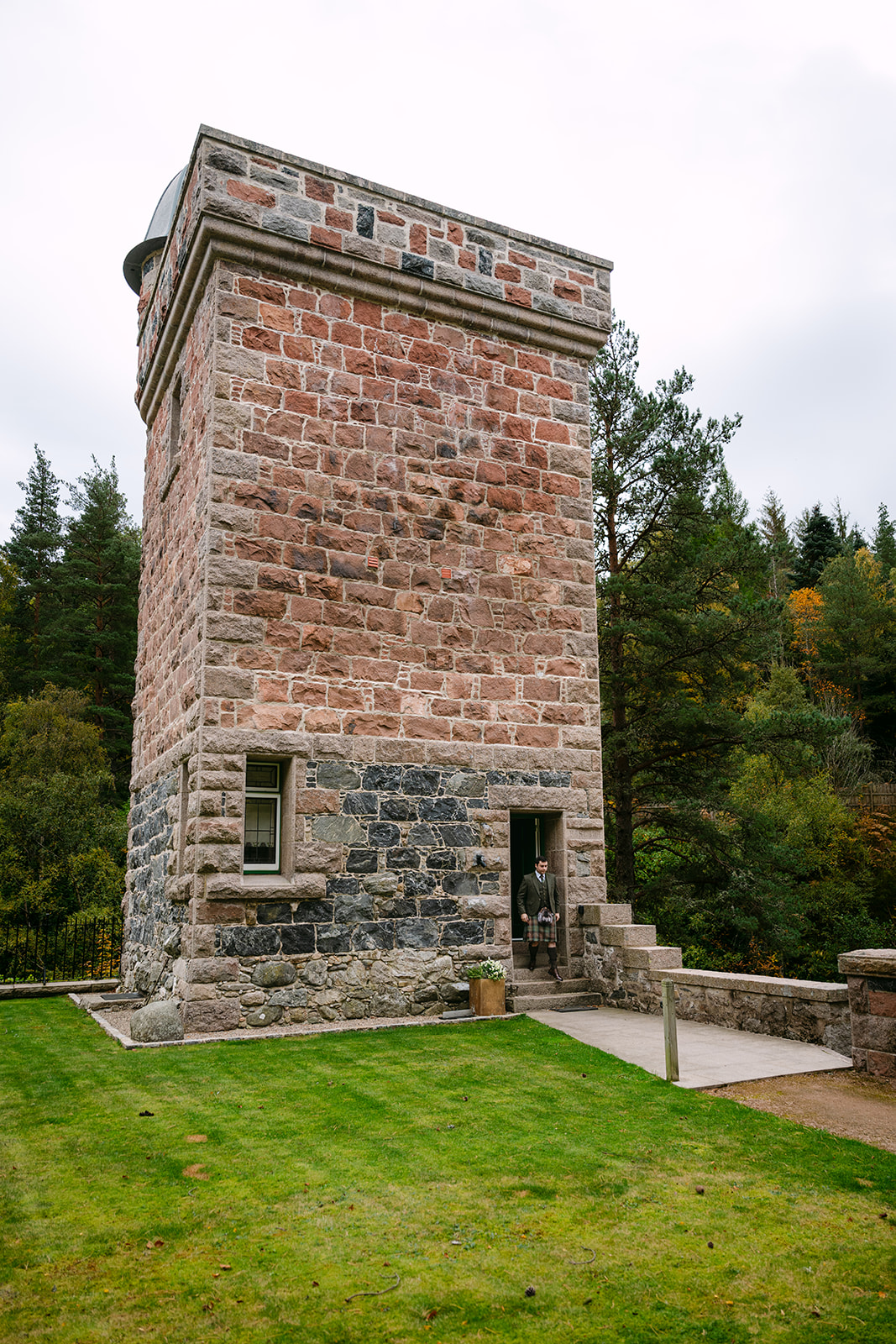 groom walks out of tower ess glen tanar