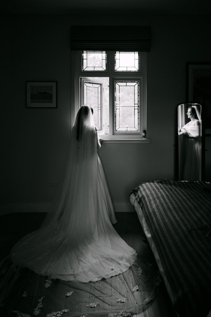 bride getting ready and looking out the window
