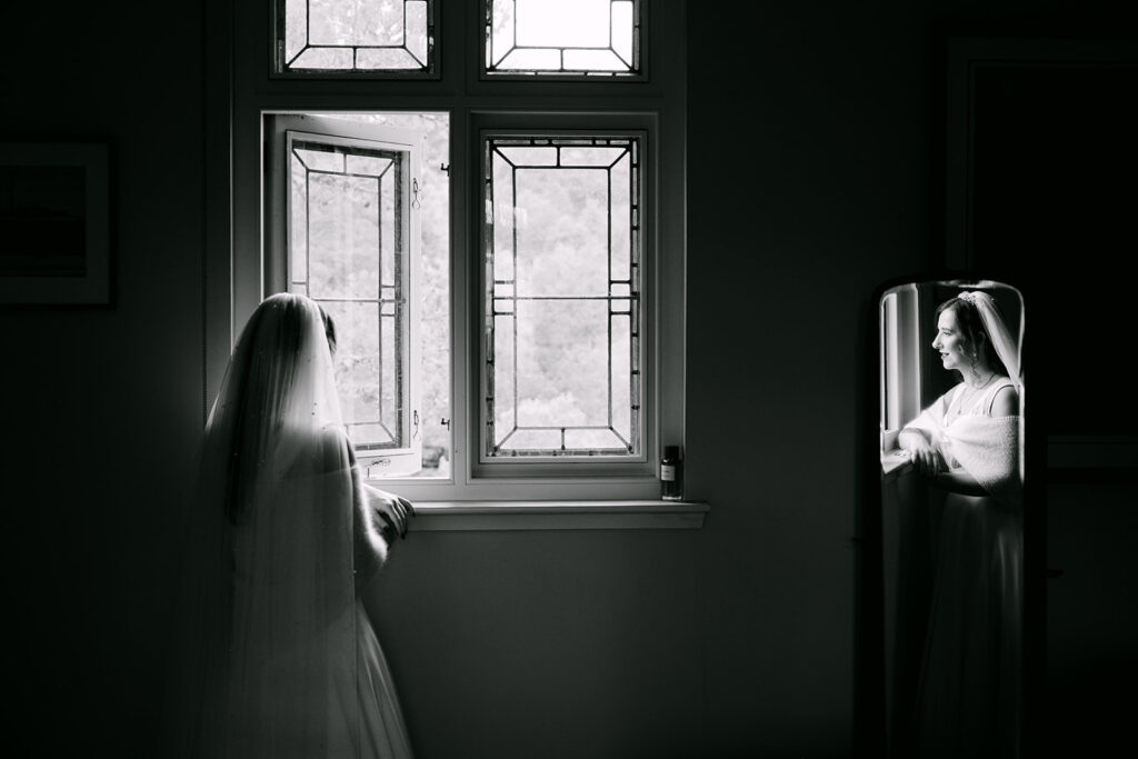 bride getting ready and looking out the window