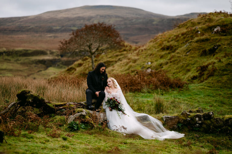 couple elopes on skye - bride rests her head on groom in fairy glen
