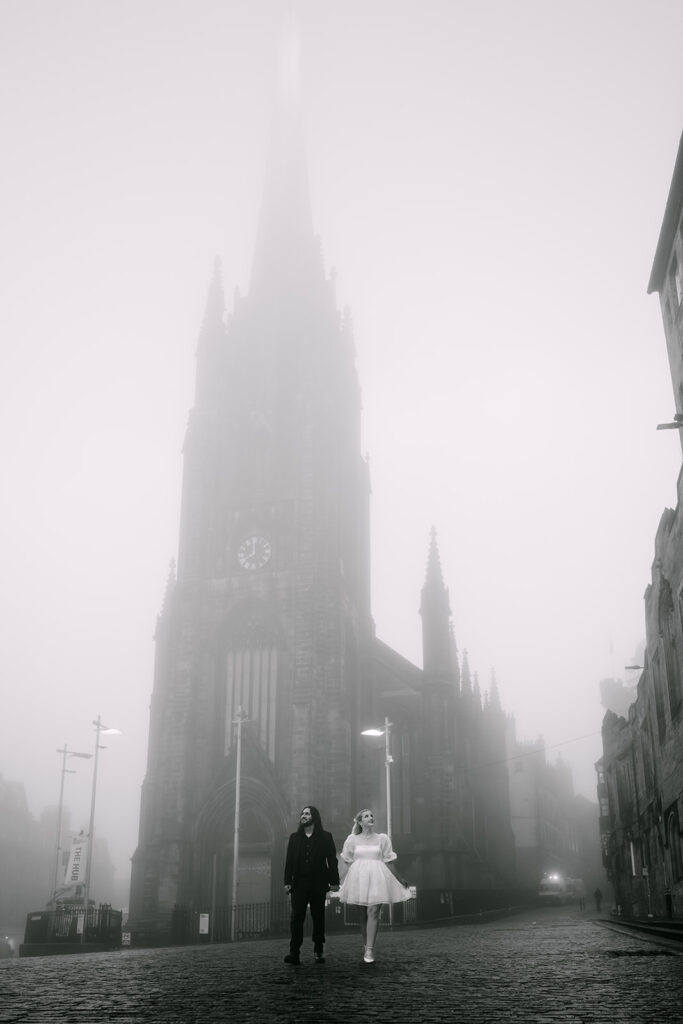 couple walks misty edinburgh streets