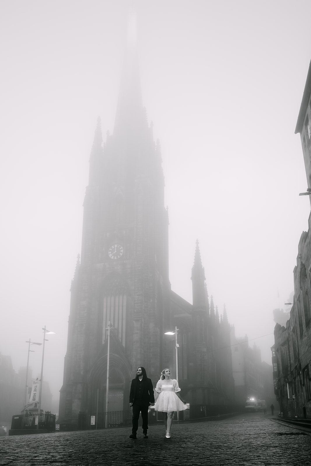 couple walks misty edinburgh streets