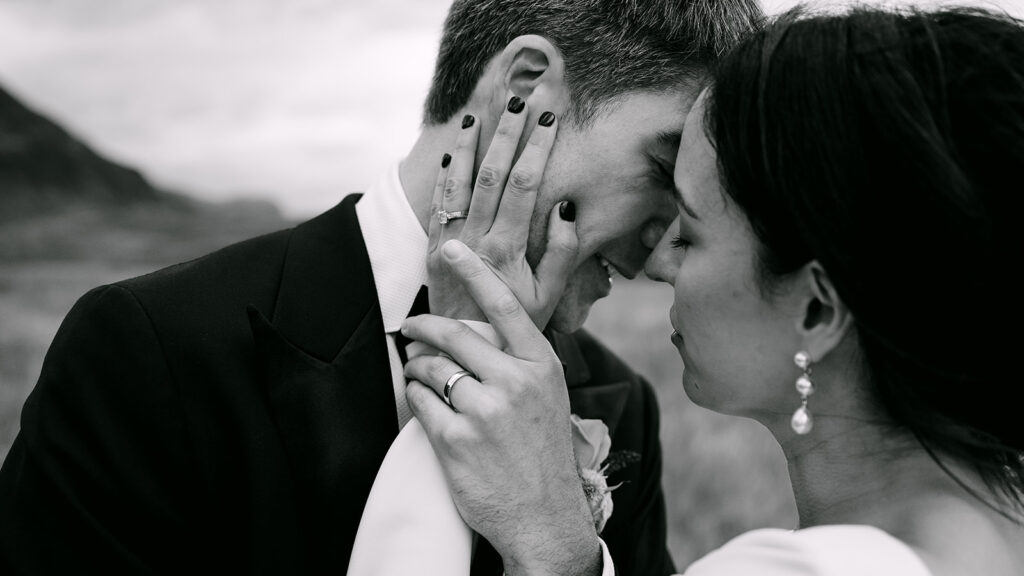 Bride and groom sharing a quiet moment and holding each other's face