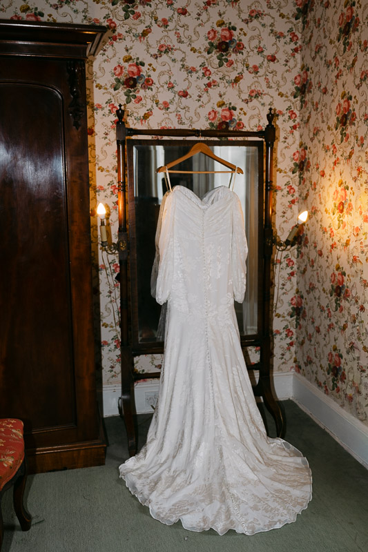 bridal gown hangs on mirror