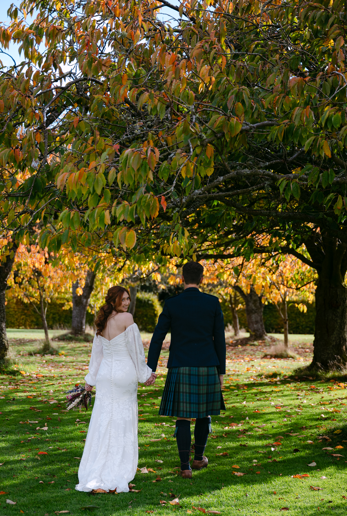 bride looks back at camera at kirknewton house stables wedding