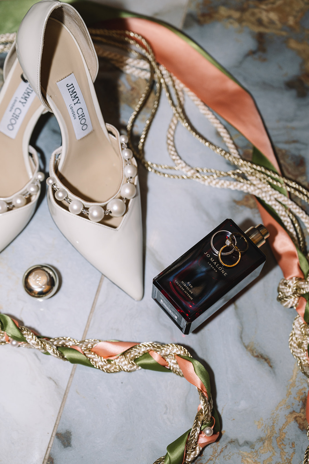 flatlay with wedding shoes, hand fasting cord, and jo malone perfume