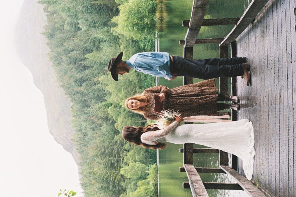 couple saying their vows at the lake in glencoe alongside their celebrant