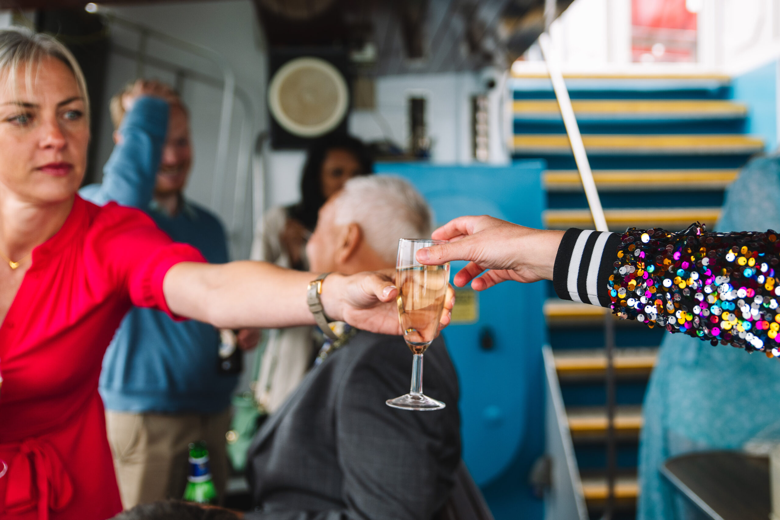 Friends sharing champagne on a boat to Inchcolm Island