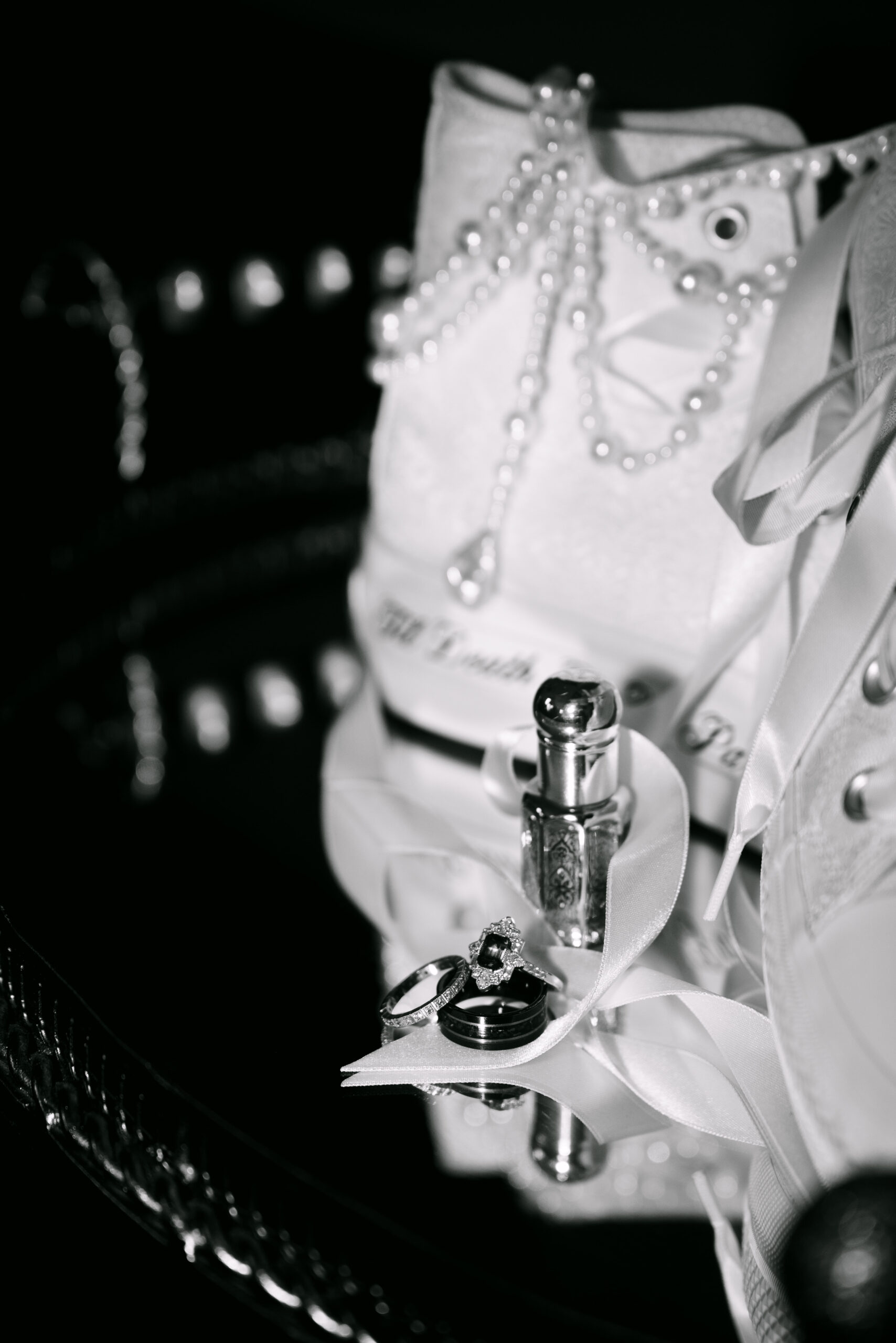 Close up shot of rings and brides converse shoes at auchen castle