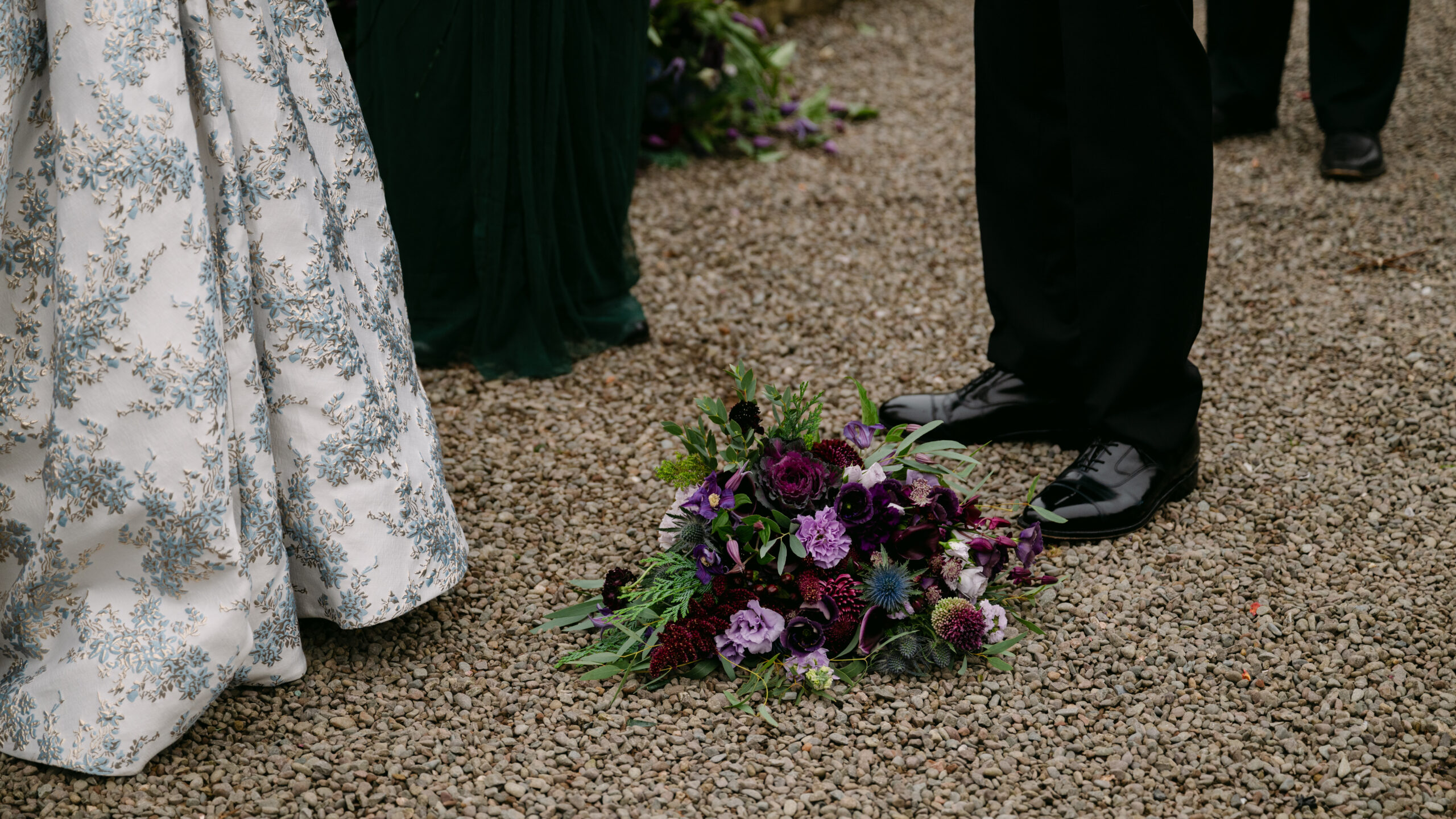 purple flowers and thistles near the bride and grooms feet at auchen castle