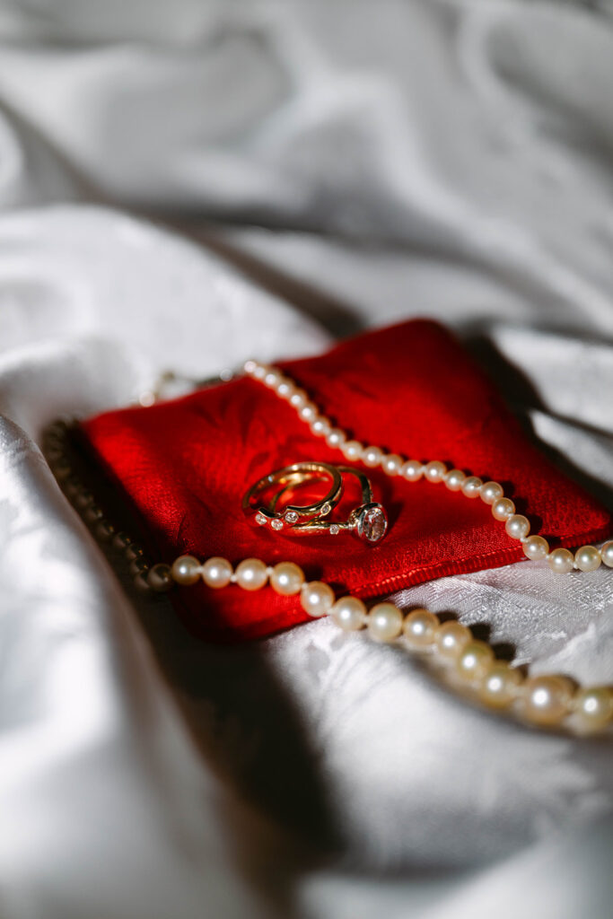 wedding detail shot of ring and pearls