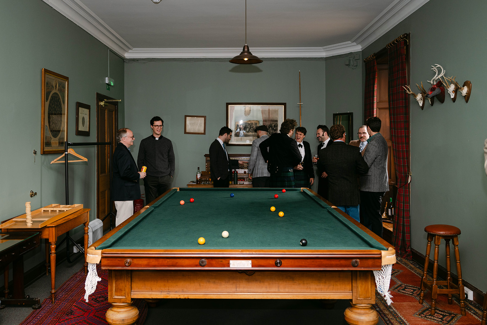 groom and groomsmen play billiards in cambo estate room